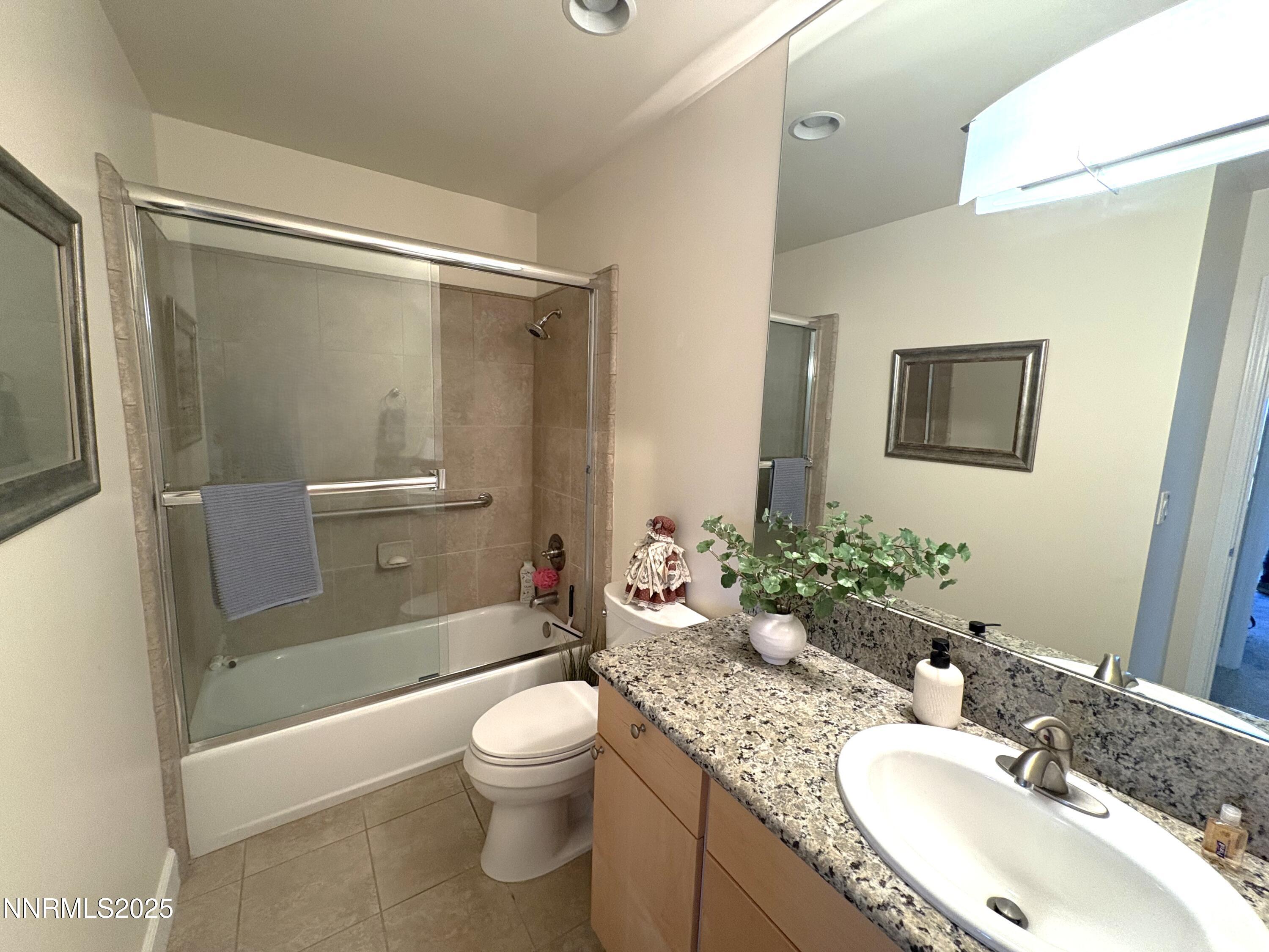 450 North Arlington Avenue, Unit 1207 Reno, NV 89503 - Photo 21 of 21 a bathroom with a granite countertop sink toilet and shower