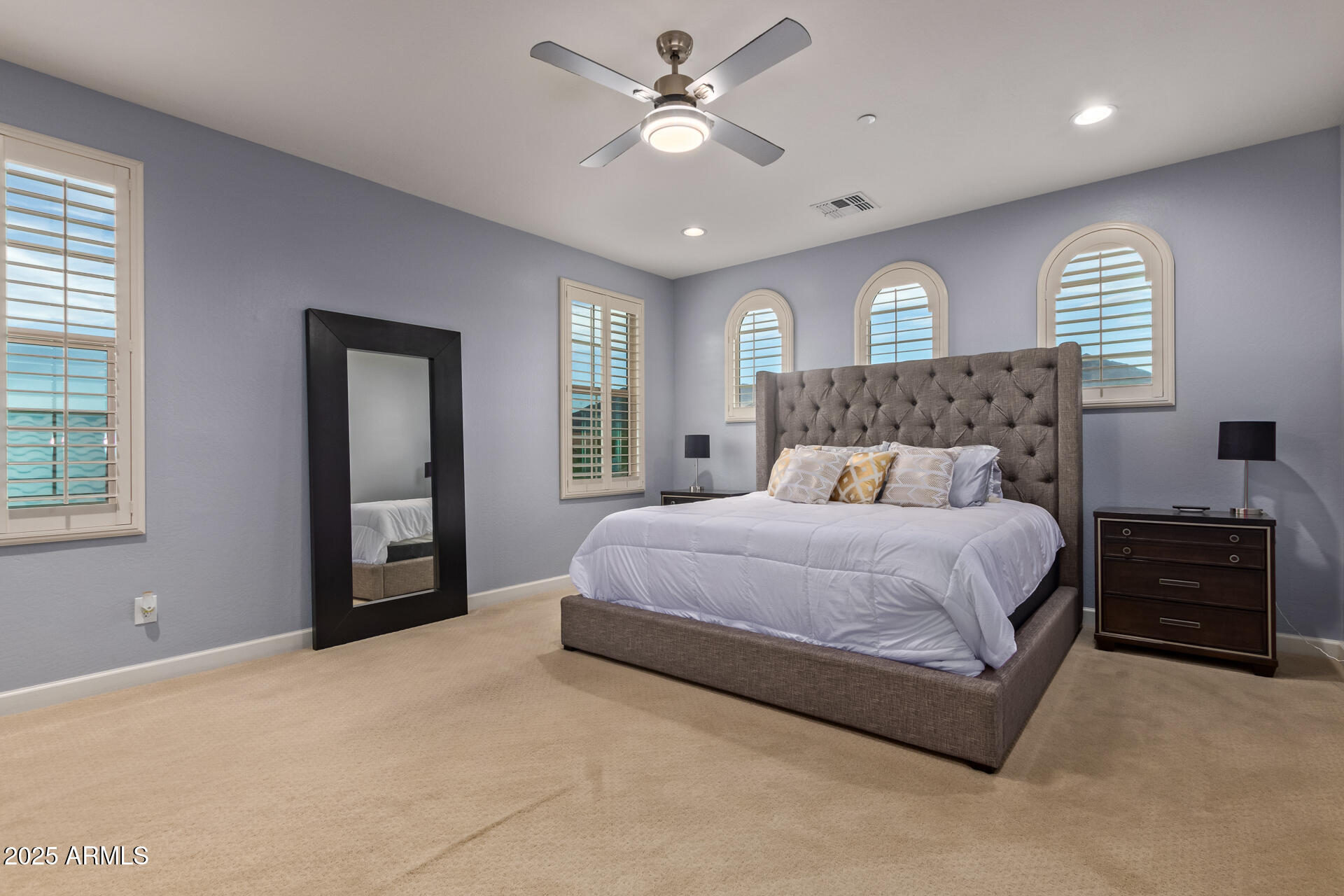 18557 North 94th Street Scottsdale, AZ 85255 - Photo 15 of 27 a bedroom with a bed and a chandelier