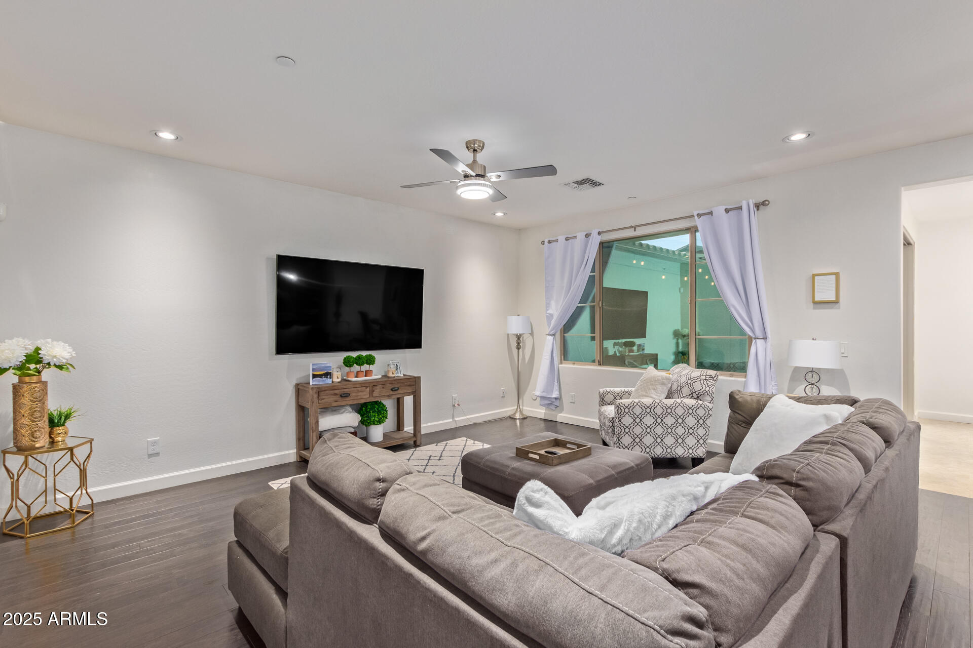 18557 North 94th Street Scottsdale, AZ 85255 - Photo 3 of 27 a living room with furniture and a flat screen tv