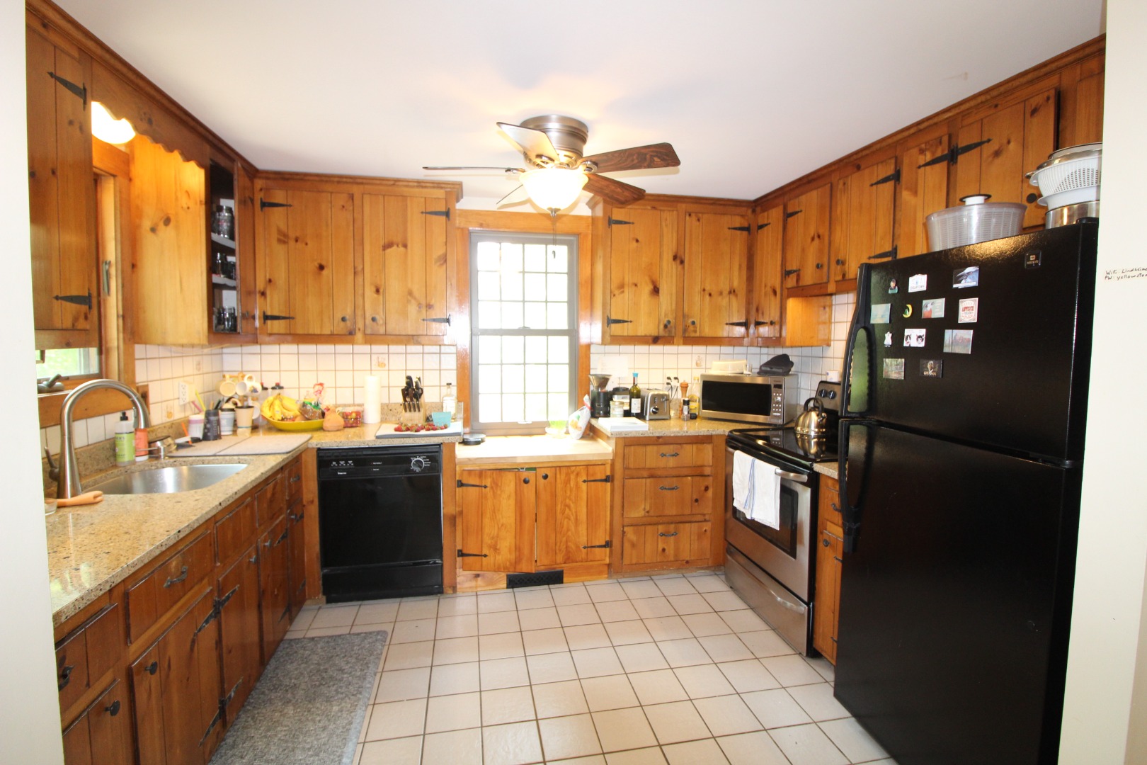 19 Vickers Street Edgartown, MA 02539 - Photo 5 of 16 a kitchen with granite countertop a refrigerator stove top oven and sink