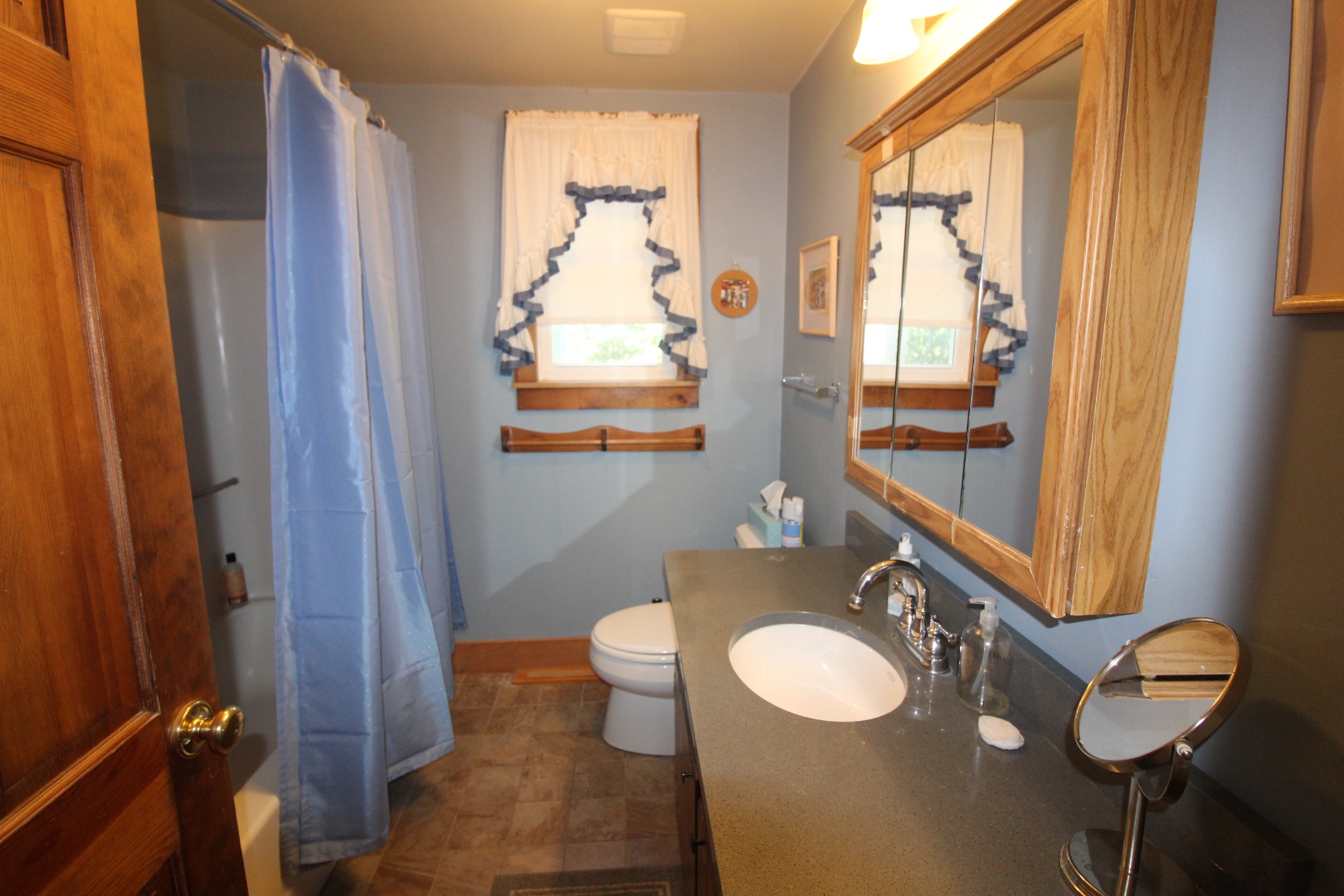 19 Vickers Street Edgartown, MA 02539 - Photo 9 of 16 a bathroom with a granite countertop sink toilet and mirror