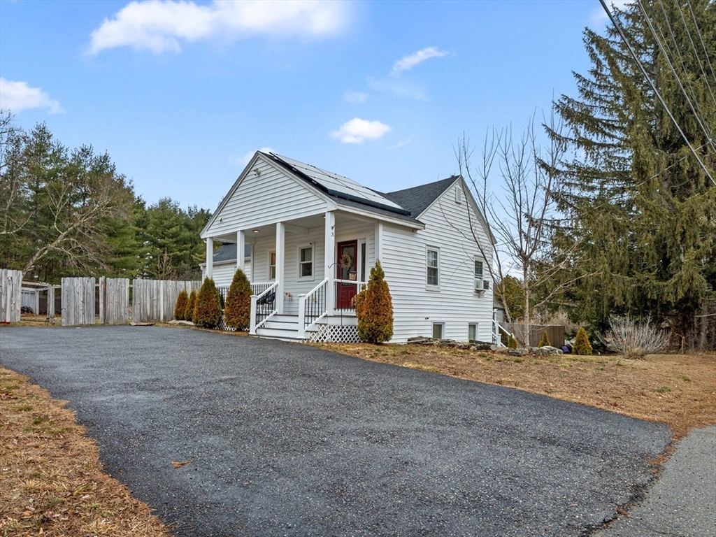 a view of a house with a yard and wooden fence