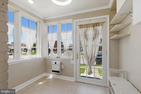 a view of an entryway with wooden floor and door