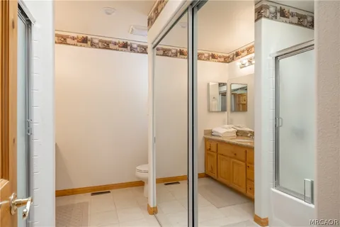 a bathroom with a granite countertop sink mirror and shower