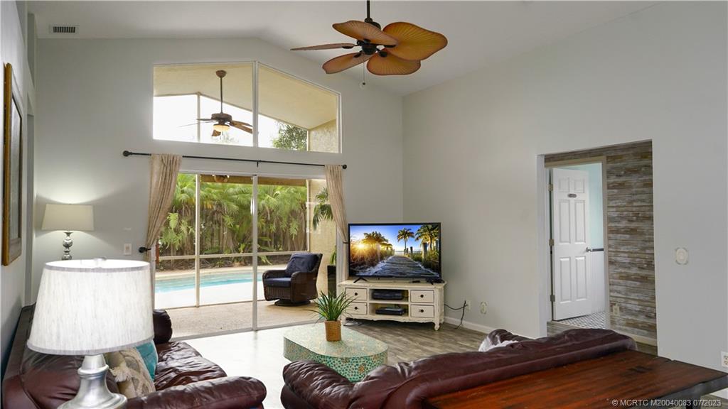 2440 Southwest Riviera Road Stuart, FL 34997 - Photo 3 of 18 a living room with furniture and a window