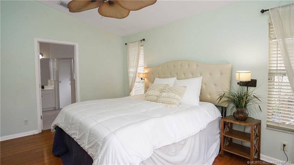 2440 Southwest Riviera Road Stuart, FL 34997 - Photo 8 of 18 a bedroom with bed and a potted plant