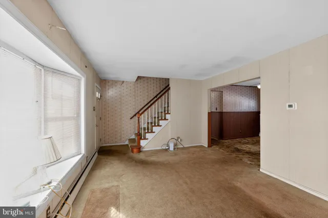 a view of entryway and hall with a front door