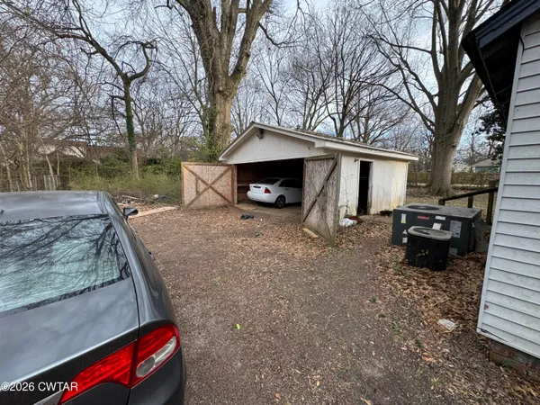 a view of a house with a backyard and garage