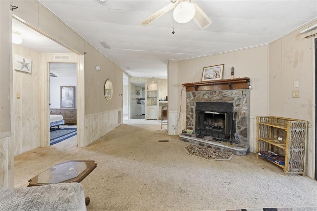 8045 Indian Trail Road Weeki Wachee, FL 34613 - Photo 24 of 49 a living room with furniture and a fireplace