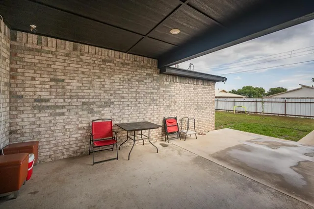 a view of a room with chairs and a garage
