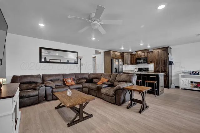 a living room with furniture and kitchen view