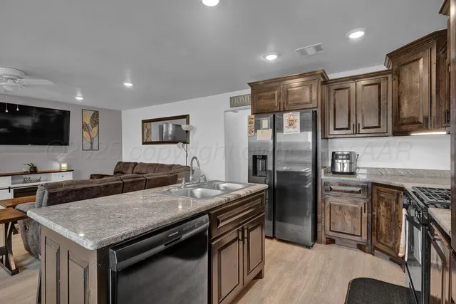 a kitchen with a stove a refrigerator and a sink