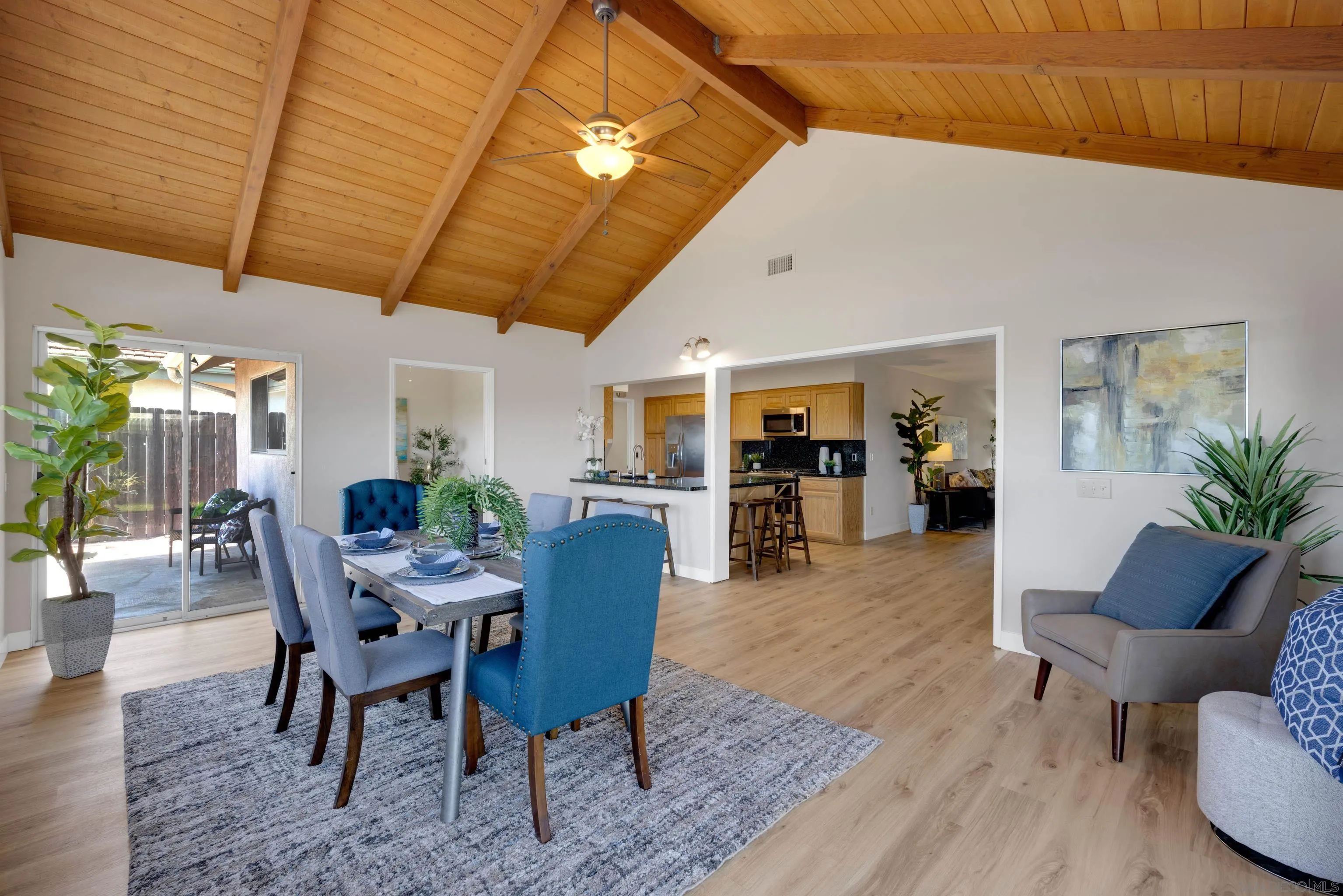 13710 Ahwahnee Way Poway, CA 92064 - Photo 13 of 43 a dining room with furniture potted plants and wooden floor