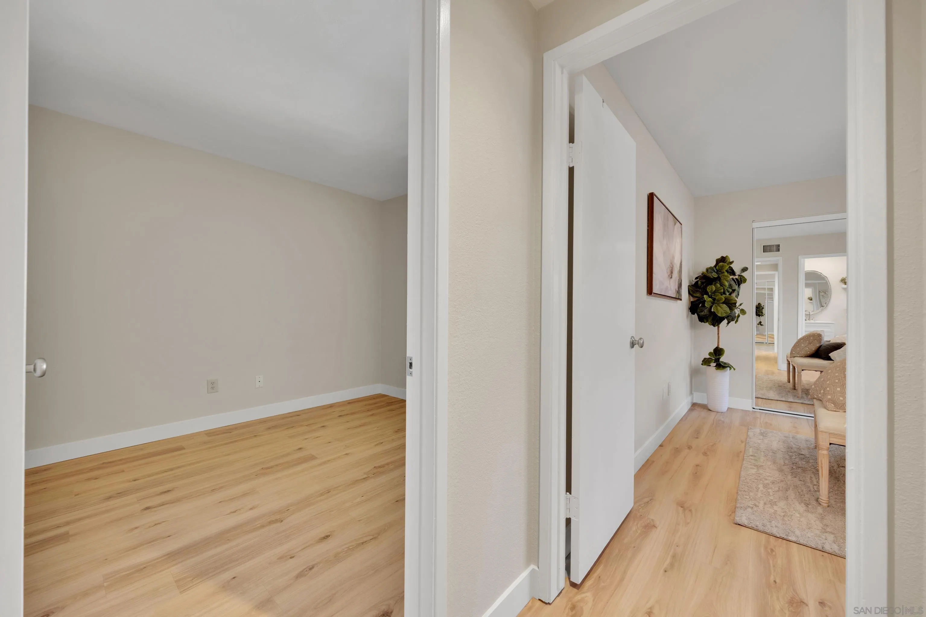 13710 Ahwahnee Way Poway, CA 92064 - Photo 23 of 43 a view of a hallway with wooden floor and a bathroom