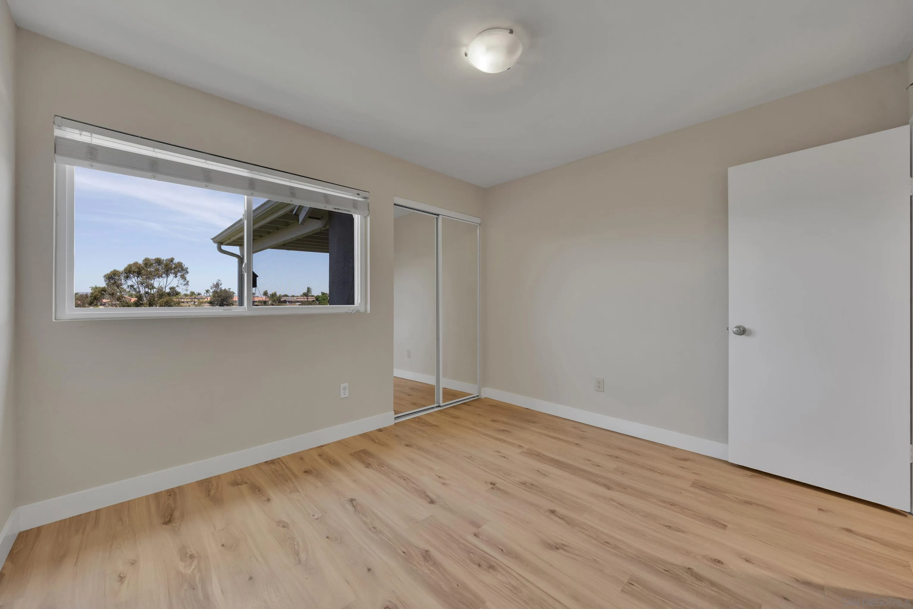 13710 Ahwahnee Way Poway, CA 92064 - Photo 27 of 43 a view of an empty room with wooden floor and window