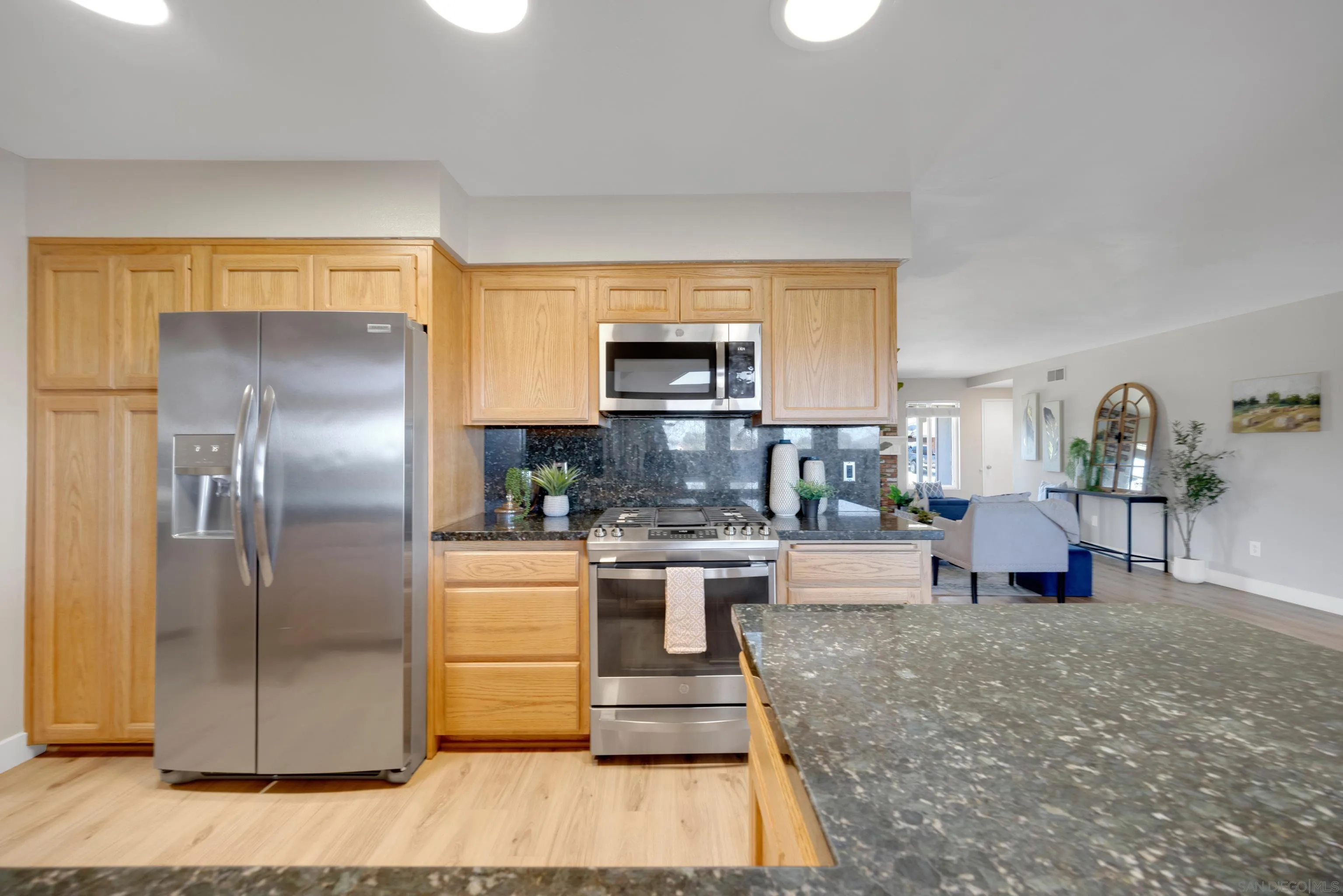 13710 Ahwahnee Way Poway, CA 92064 - Photo 10 of 43 a kitchen with a refrigerator and a stove top oven