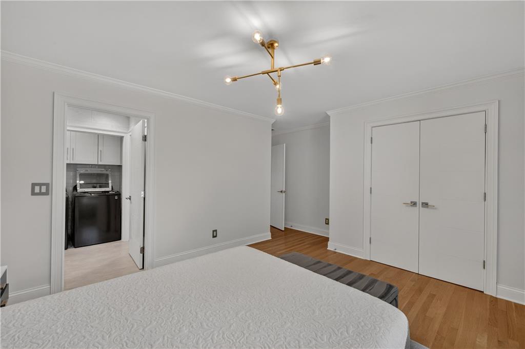4610 West Morton Road Alpharetta, GA 30022 - Photo 22 of 53 a bedroom with a bed and a chandelier fan