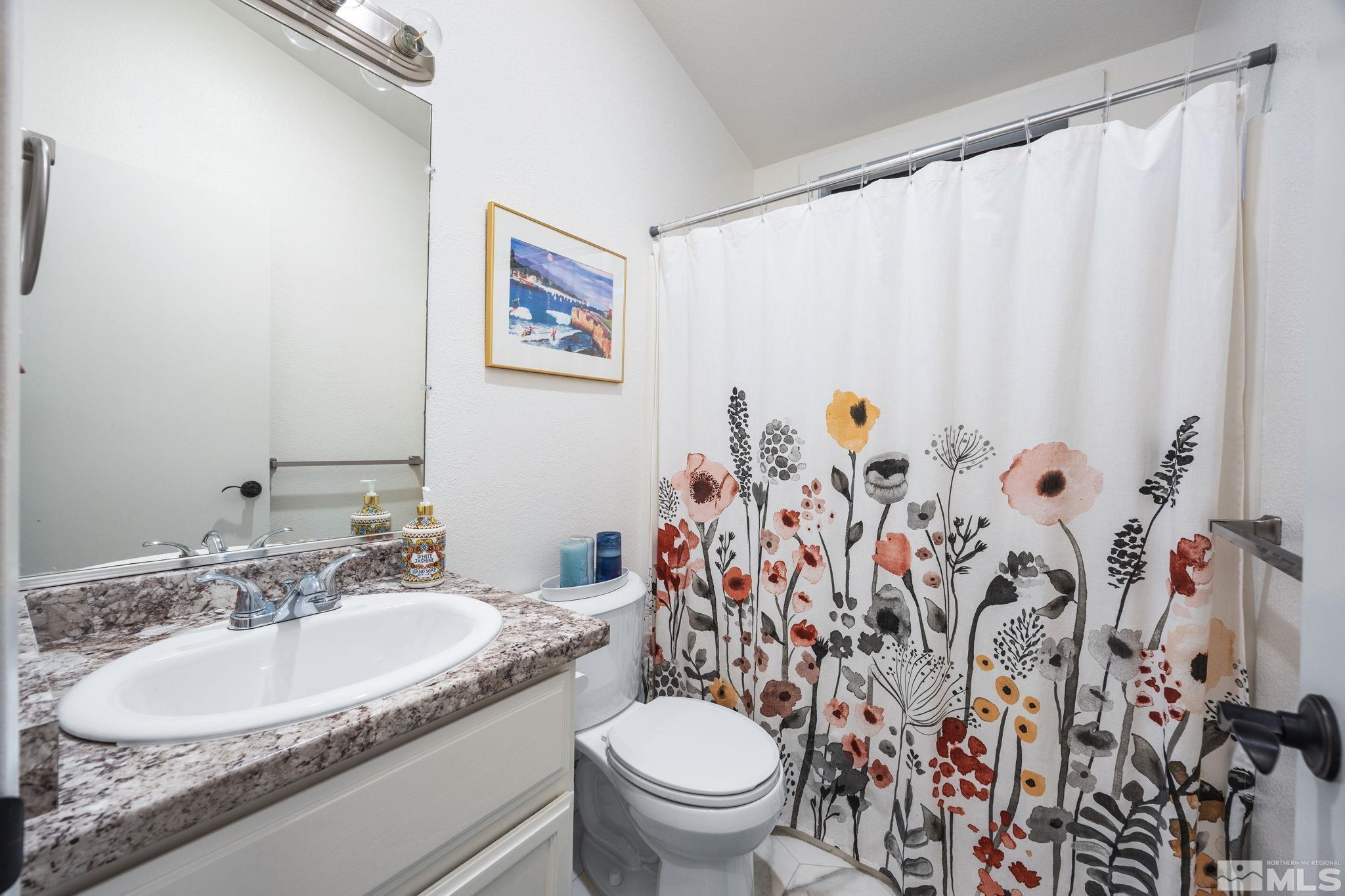 115 Stonecrest Drive Verdi, NV 89439 - Photo 24 of 28 a bathroom with a granite countertop sink and a mirror with toilet