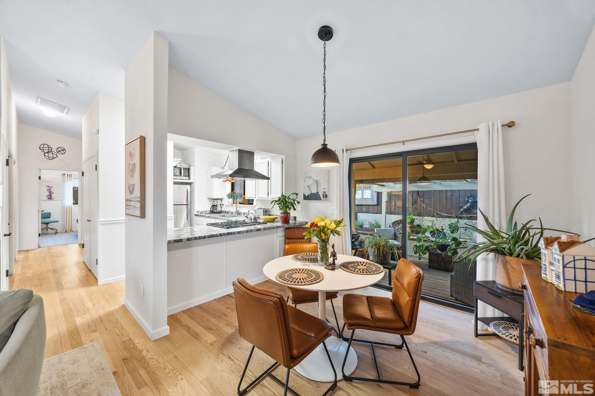 115 Stonecrest Drive Verdi, NV 89439 - Photo 5 of 28 a dining room with furniture a chandelier and wooden floor
