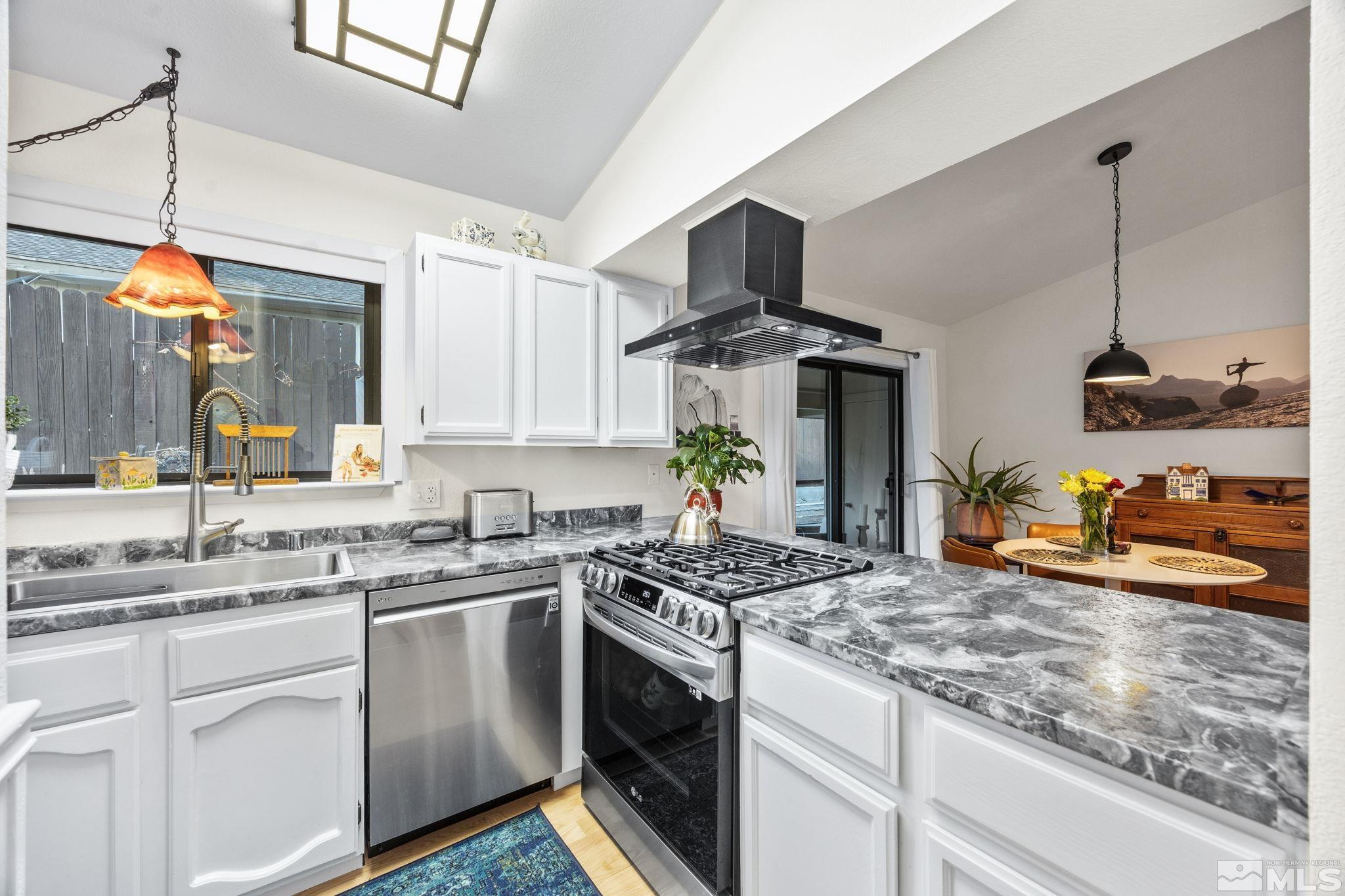 115 Stonecrest Drive Verdi, NV 89439 - Photo 7 of 28 a kitchen with stainless steel appliances granite countertop a sink a stove and a wooden floors