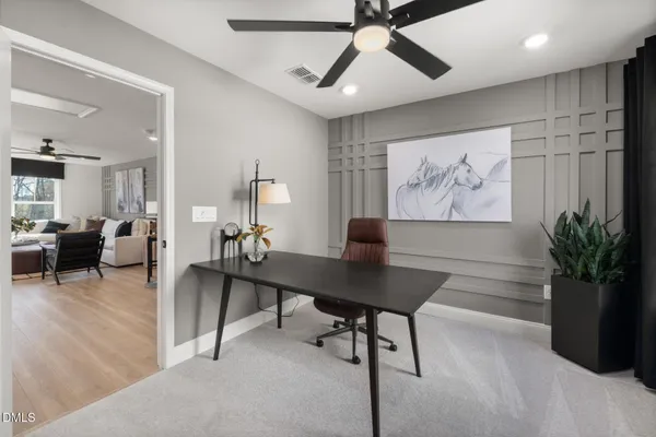 a living room with lots of furniture and a wooden floor