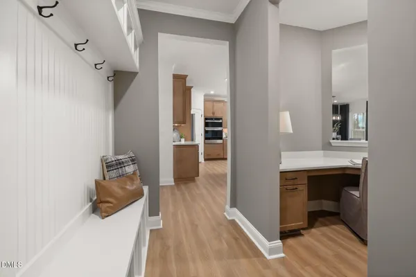 a view of hallway with wooden floor