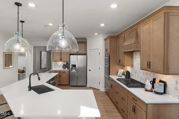 a kitchen with stainless steel appliances granite countertop a sink window and refrigerator
