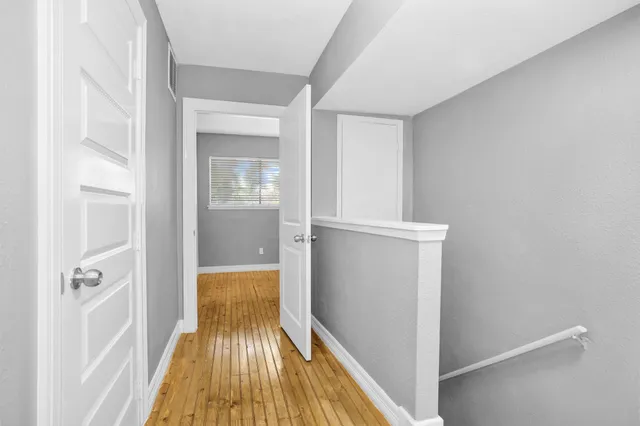 a view of a hallway view with wooden floor and staircase