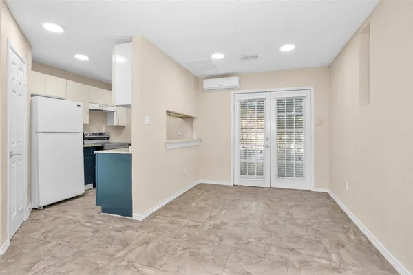 a view of an empty room with a kitchen