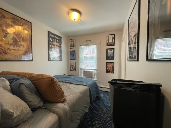 a bedroom with a bed window and wall painting