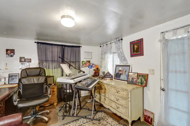 a view of a workspace with furniture and a workspace