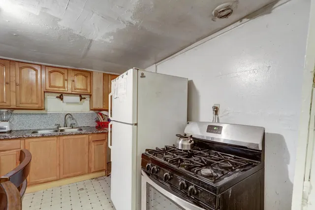 a kitchen with a stove and a refrigerator