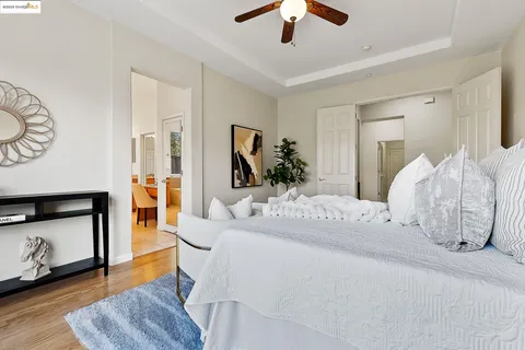 a spacious bathroom with a granite countertop sink mirror and a bathtub
