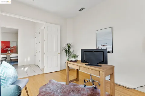 a view of an empty room with wooden floor