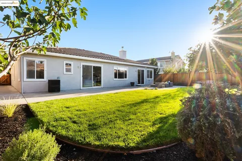 a front view of a house with garden and patio