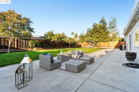 a porch with a potted plant next to a window
