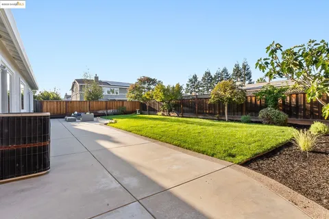 a front view of a house with a garden and patio