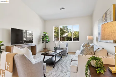 a living room with furniture a window and a flat screen tv