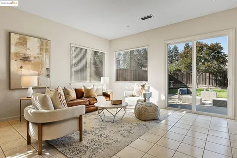 a living room with furniture and large windows