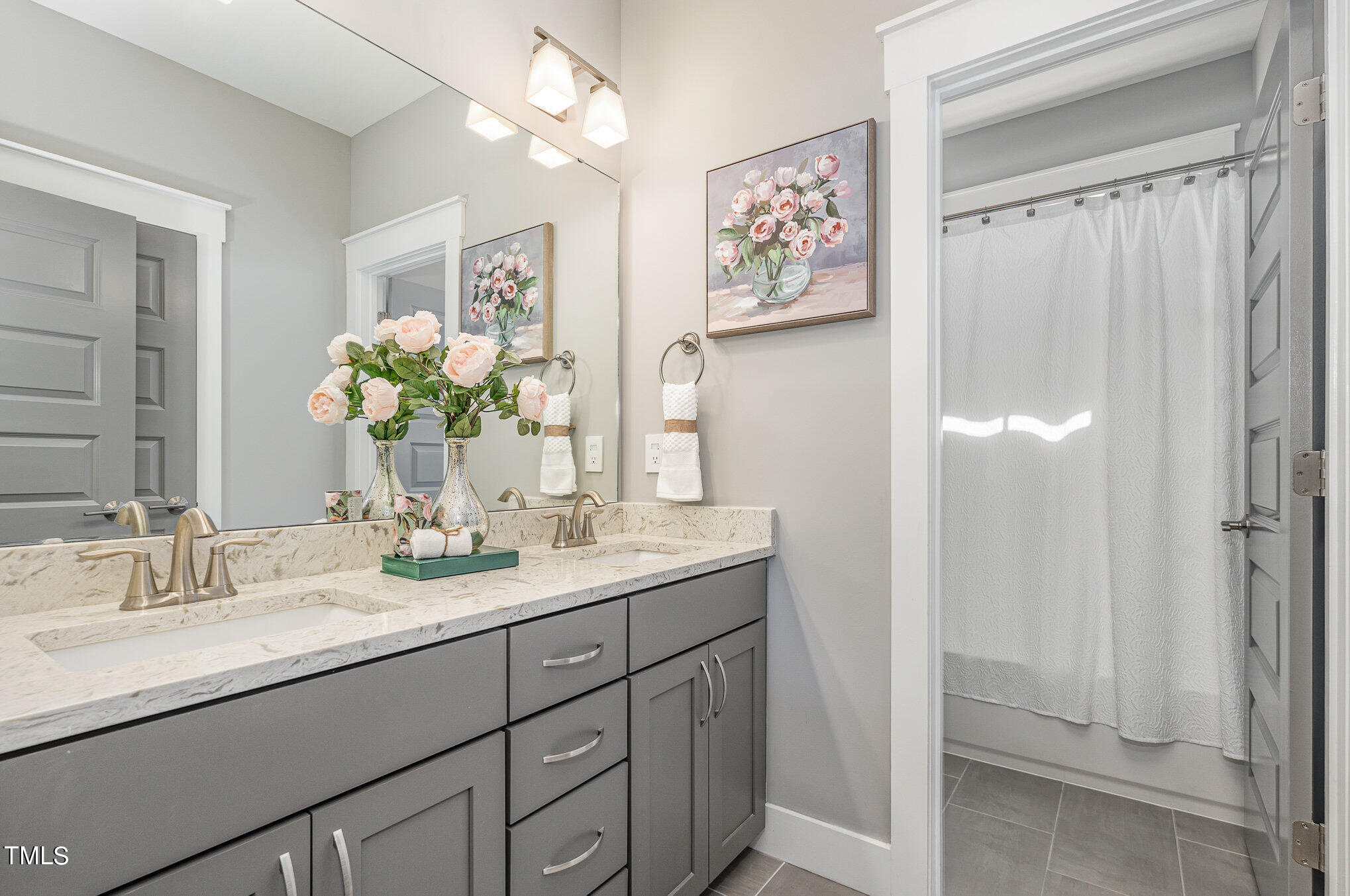 719 East Lenoir Street Raleigh, NC 27601 - Photo 11 of 16 a bathroom with a double vanity sink and a mirror