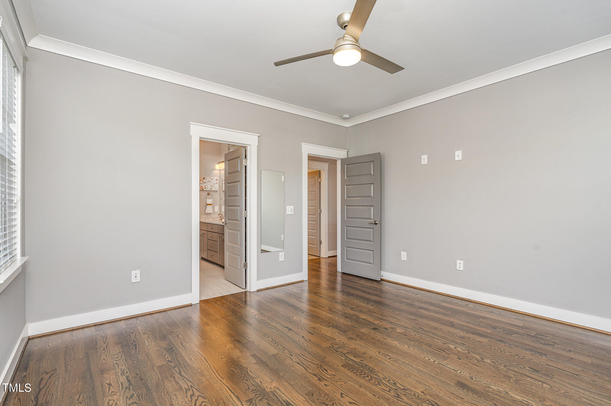 719 East Lenoir Street Raleigh, NC 27601 - Photo 7 of 16 an empty room with wooden floor and ceiling fan
