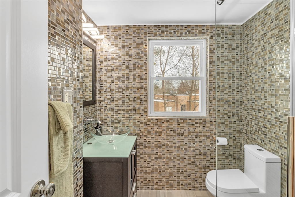 231 Lagrange Street Boston, MA 02132 - Photo 27 of 42 a bathroom with a toilet sink and mirror