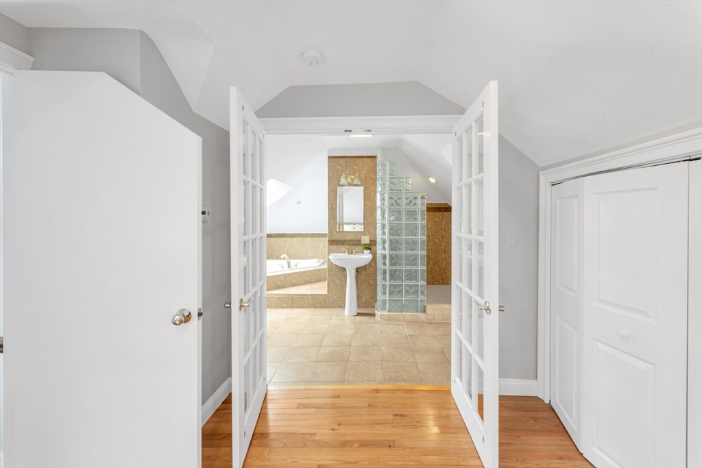 231 Lagrange Street Boston, MA 02132 - Photo 32 of 42 a view of a hallway with wooden floor and dining room
