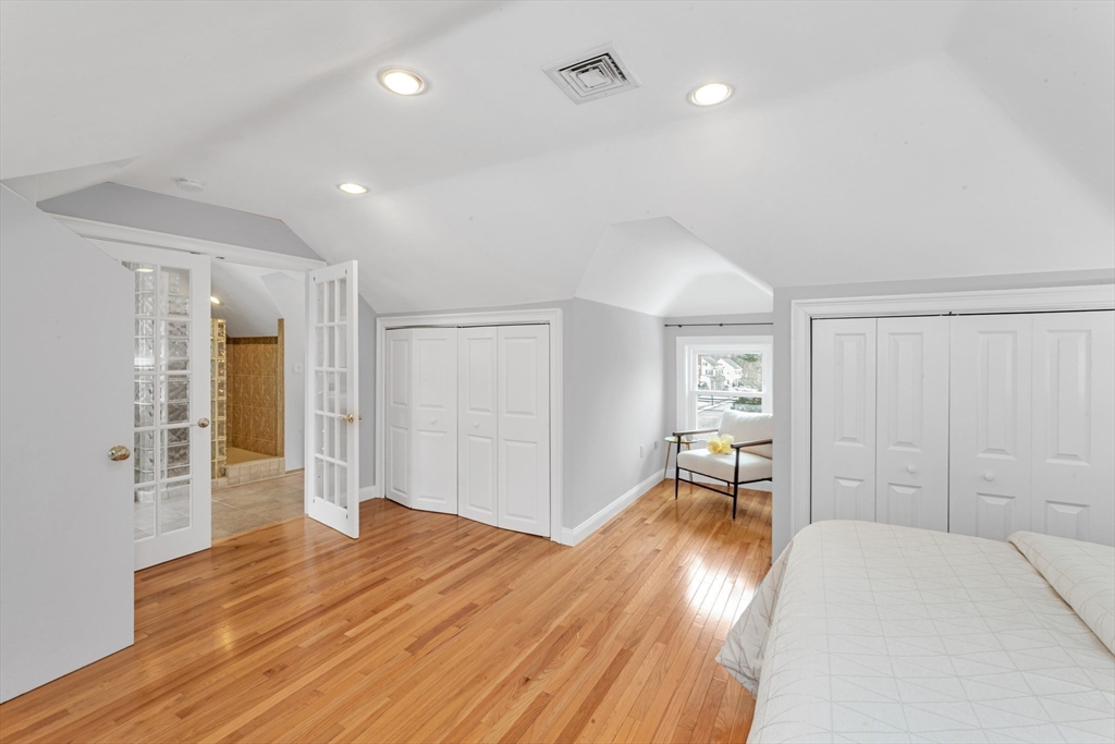 231 Lagrange Street Boston, MA 02132 - Photo 33 of 42 a room that has a bed and a chair in it