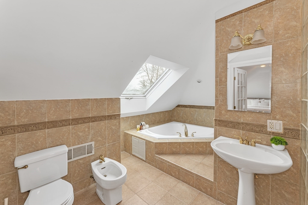 231 Lagrange Street Boston, MA 02132 - Photo 35 of 42 a bathroom with a sink a toilet and a mirror