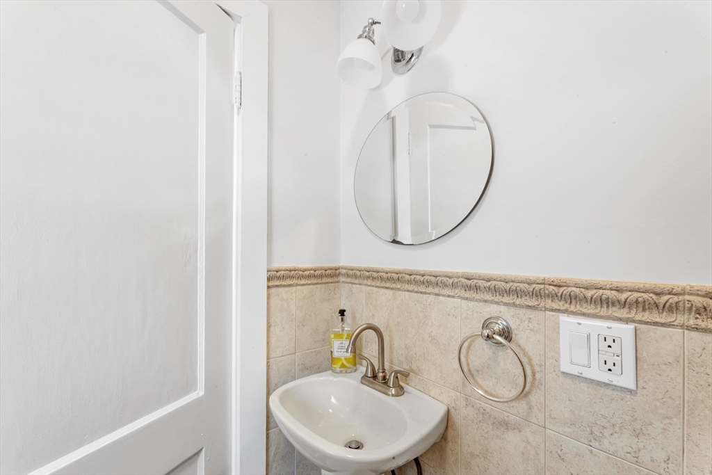 231 Lagrange Street Boston, MA 02132 - Photo 38 of 42 a bathroom with a sink and a mirror
