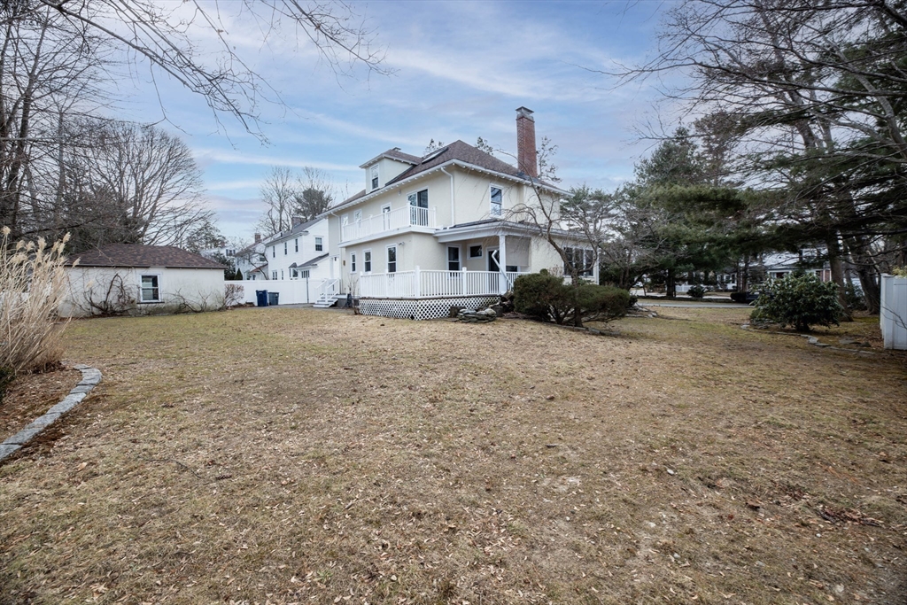 231 Lagrange Street Boston, MA 02132 - Photo 40 of 42 a view of a house with a large tree in front of it