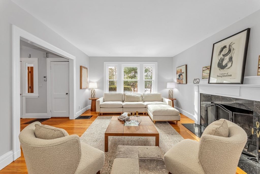 231 Lagrange Street Boston, MA 02132 - Photo 7 of 42 a living room with furniture and a fireplace