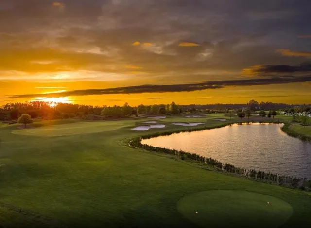 a view of a house with swimming pool and sitting area