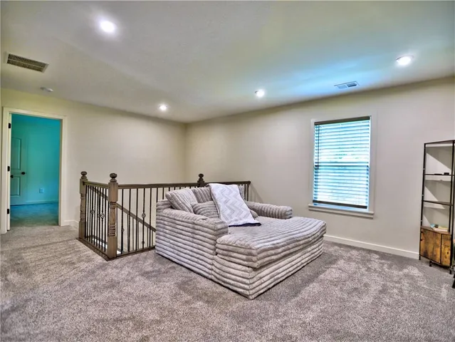 a spacious bedroom with a bed and a window